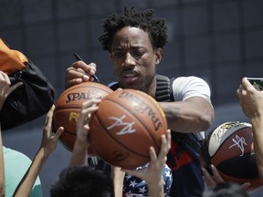 DeMar DeRozan signs a fan's basketball during a training camp for USA basketball, Thursday, July 26, 2018, in Las Vegas.