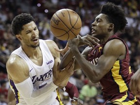 Los Angeles Lakers' Josh Hart, left, and Cleveland Cavaliers' Collin Sexton battle for the ball during the second half of an NBA summer league basketball game, Monday, July 16, 2018, in Las Vegas.