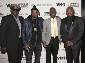 FILE - In this Feb. 20, 2014 file photo, from left, recording artists Fab Five Freddy and Nas, fashion designer Dapper Dan and author Steve Stoute attend a screening of "The Tanning of America: One Nation Under Hip Hop" in New York. Harlem designer Dapper Dan spent years in the 1980s with a client list that included the who's who of hip-hop before legal issues over the clothes he was making got in the way. Now the fashion groundbreaker is back after more than two decades out of the public eye. He's got a partnership with Gucci and the likes of superstar entertainer Beyonce among those wearing his designs.