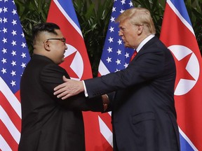 In this Tuesday, June 12, 2018 file photo, U.S. President Donald Trump shakes hands with North Korea leader Kim Jong Un at the Capella resort on Sentosa Island in Singapore.