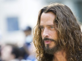 FILE - In this Sept. 11, 2011 file photo, lead Singer of Soundgarden Chris Cornell poses for photographs on the red carpet as he arrives for the movie "Machine Gun Preacher" at the Toronto International Film Festival in Toronto.  The late grunge pioneer will be remembered in the city where he was born. Cornell's wife, Vicky, on Friday, July 20, 2018, announced a statue will be erected on Aug. 29 at Seattle's Museum of Pop Culture. The announcement comes on what would have been Cornell's 54th birthday.