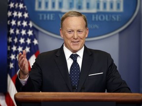 FILE - In this Tuesday, June 20, 2017, file photo, then-White House press secretary Sean Spicer smiles as he answers a question during a briefing at the White House,  in Washington.  A black man has accused the former White House press secretary of calling him a racial slur when they were students at a Rhode Island prep school. Spicer was at a book signing in Middletown on Friday, July 27 to promote his new book reflecting on his time at the press podium for President Donald Trump. Cambridge, Mass., resident Alex Lombard yelled out Spicer's name and accused Spicer of calling him the N-word and trying to fight him when they attended Portsmouth Abbey School.
