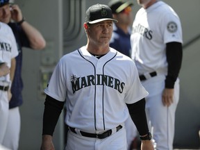 FILE - In this May 27, 2018, file photo, Seattle Mariners manager Scott Servais walks in the dugout during the eighth inning of a baseball game against the Minnesota Twins, in Seattle. The Seattle Mariners have given manager Scott Servais a multiyear contract extension with the club in position to potentially end the longest current playoff drought in the four major pro sports. Seattle announced the extension for Servais on Friday, July 20, 2018, with the Mariners sitting at 58-39 and holding the second wild-card spot in the American League with the second half of the season about to begin.
