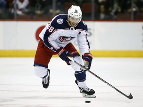 FILE - In this Jan. 25, 2018, file photo, Columbus Blue Jackets center Boone Jenner skates with the puck against the Arizona Coyotes during the first period of an NHL hockey game, in Glendale, Ariz. The Columbus Blue Jackets have signed forward Boone Jenner to a four-year contract extension. The 25-year-old Dorchester, Ontario, native has been a stalwart presence in the emergence of the Blue Jackets as a playoff team in the last two seasons. The contract signed Wednesday, July 4, 2018, locks up Jenner through the 2021-22 season.