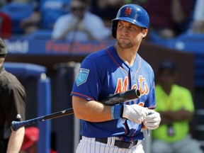 FILE - In this March 2, 2018, file photo, New York Mets' Tim Tebow walks back to the dugout after striking out during the second inning of an exhibition spring training baseball game against the Washington Nationals, in Port St. Lucie, Fla. Mets minor leaguer Tim Tebow is set for hand surgery Tuesday, July 24, 2018,  and likely done for the season, dashing his hopes of playing in the majors this year. The 30-year-old outfielder will have surgery in New York to remove his broken right hamate bone. He hurt himself last week swinging the bat.