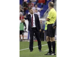 FILE - In this July 29, 2017, file photo, New York Red Bulls coach Jesse Marsch, left, talks to  official Silviu Petrescu during the second half of the team's MLS soccer match against the Montreal Impact, in Harrison, N.J. Marsch has resigned as coach of Major League Soccer's New York Red Bulls and has been replaced by top assistant Chris Armas, a former U.S. national team defender.The Red Bulls made the announcement on Friday, July 6, 2018.