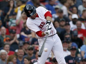 FILE - In this May 20, 2018, file photo, Boston Red Sox's J.D. Martinez hits a two-run home run during the fifth inning against the Baltimore Orioles in a baseball game in Boston. Martinez's preparation amazes even the hardest-working major leaguers, and it's worked. He was named an All-Star for the third time this season by leading the majors with 28 homers and 79 RBIs in his first year with Boston. He signed a $110 million, five-year deal with the Red Sox in the offseason, a long way from his early career struggles with Houston.