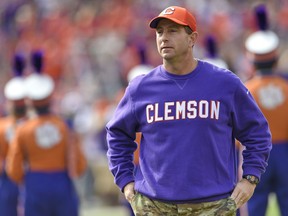 FILE - In this Saturday, Nov. 18, 2017 file photo, Clemson head coach Dabo Swinney watches before the start of an NCAA college football game against Citadel in Clemson, S.C. Clemson's disappointing loss in the College Football Playoff to Alabama last January is never far from players' minds as they prepare for the upcoming season.