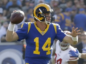 FILE - In this Dec. 31, 2017, file photo, Los Angeles Rams quarterback Sean Mannion passes against the San Francisco 49ers during the first half of an NFL football game in Los Angeles. The Rams have listened to their fans and increased their use of their classic blue-and-yellow jerseys this season. The Rams have announced they will wear their "throwback" jerseys in their final five home games at the Coliseum this season. The franchise has received intense calls for the return of the classic uniforms from their Los Angeles fan base since the team returned to California in 2016. Chief operating officer Kevin Demoff says the Rams talked to the NFL and got approval.