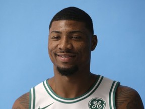 FILE - In this Sept. 25, 2017, file photo, Boston Celtics' Marcus Smart poses during NBA basketball media day, in Canton, Mass. The Celtics have re-signed guard Marcus Smart. A person with knowledge of the agreement tells The Associated Press that Smart signed a four-year, $52 million contract with the Celtics. The person spoke to the AP on condition of anonymity Thursday, July 19, 2018,  because the team did not disclose the terms of the contract.