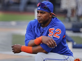 FILE - In this July 20, 2018, file photo, New York Mets' Yoenis Cespedes stretches before the team's baseball game against the New York Yankees in New York. Cespedes is back on the disabled list, and the Mets are still deciding whether the oft-injured slugger needs surgery on both feet that would require an eight-to-10-month recovery.