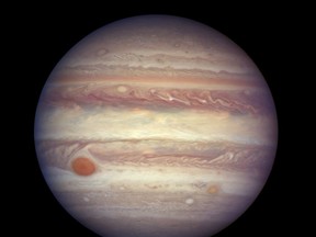 FILE - This April 3, 2017 image made available by NASA shows the planet Jupiter.   A team of astronomers is reporting the recent discovery of a dozen new moons circling the giant gas planet. That brings the number of moons at Jupiter to 79, the most of any planet.  The astronomers were looking for objects on the fringes of the solar system when they spotted the Jupiter moons. They found a dozen small moons. The confirmation of 10 was announced Tuesday, July 17, 2018; two were confirmed earlier. They're calling one moon an 'oddball' because of its unusual orbit. (NASA, ESA, and A. Simon (GSFC) via AP, File)