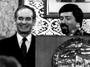 FILE - In a Jan. 12, 1982 file photo, Iowa Governor Robert Ray, left, enjoys a light moment at the Statehouse podium with Lt. Governor Terry Branstad after the Condition of the State speech. Former longtime Iowa Gov. Robert D. Ray, who helped thousands of Vietnam War refugees relocate to the state and defined Iowa's GOP politics for years, died Sunday, July 8, 2018, according to Ray's former chief of staff David Oman. He was 89.