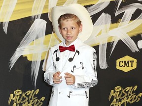 FILE - In this June 6, 2018, file photo, Mason Ramsey arrives at the CMT Music Awards at the Bridgestone Arena in Nashville, Tenn. Ramsey, a preteen Illinois boy who went viral online in a video of him singing and yodeling in a Walmart store is releasing his first album July 20.