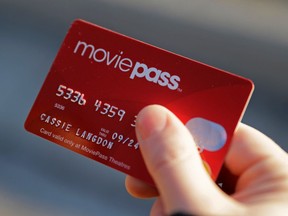 FILE - In this Jan. 30, 2018, file photo, Cassie Langdon holds her MoviePass card outside AMC Indianapolis 17 theatre in Indianapolis. MoviePass, the discount service for movie tickets, is raising prices by 50 percent and barring viewings of most major releases during the first two weeks.