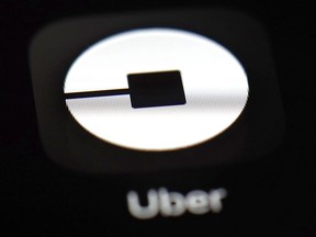 FILE - This March 20, 2018, file photo shows the Uber app on an iPad in Baltimore. U.S. employment regulators are investigating allegations that Uber set up a pay scale that discriminated against women working for the ride-hailing service.