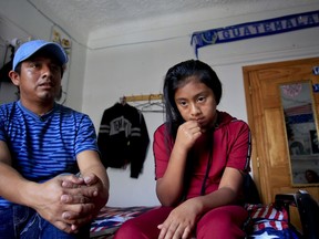 Manuel Marcelino Tzah, left, and his daughter Manuela Adriana, 11, sit inside their apartment during an interview hours after her release from immigrant detention, Wednesday July 18, 2018, in Brooklyn borough of New York. The Guatemalan asylum seekers were separated May 15 after they crossed the U.S. border in Texas.