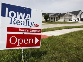 In this Wednesday, June 27, 2018, photo, an open house sign is seen on a street corner in Waukee, Iowa. On Thursday, July 5, Freddie Mac reports on the week's average U.S. mortgage rates.
