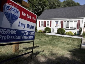 In this Monday, July 9, 2018, photo a for sale sign stands outside a pre-existing home, in Walpole, Mass. On Thursday, July 12, Freddie Mac reports on the week's average U.S. mortgage rates.