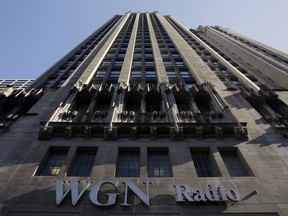 FILE - In this Monday, May 1, 2017, file photo, the WGN Radio sign appears on the side of Tribune Tower, in downtown Chicago. The Federal Communications Commission will review Sinclair's $3.9 billion deal for Tribune's television stations after its chairman raised "serious concerns."