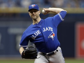 FILE - In this June 13, 2018, file photo, Toronto Blue Jays' J.A. Happ pitches to the Tampa Bay Rays during the first inning of a baseball game in St. Petersburg, Fla. . A person with knowledge of the talks tells The Associated Press the New York Yankees are nearing a deal to acquire Happ from Toronto to bolster their starting rotation.  The Yankees would send infielder Brandon Drury and minor league outfielder Bill McKinney to the Blue Jays, the person said Thursday, July 26, 2018, speaking on condition of anonymity because the trade was subject to the teams approving medical records.
