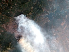 This satellite image provided by Digital Globe captured July 27, 2018 shows the Carr wildfire in Redding, Calif.   The wildfire has burned hundreds of homes and killed several people. (Satellite Image ©2018 DigitalGlobe, a Maxar company via AP)