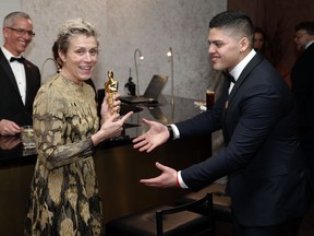 FILE - In this March 4, 2018 file photo, Frances McDormand, winner of the award for best performance by an actress in a leading role for "Three Billboards Outside Ebbing, Missouri", left, and her son Pedro McDormand Coen attend the Governors Ball after the Oscars in Los Angeles. A Los Angeles judge says that there is sufficient evidence for Terry Bryant to stand trial on grand theft charges for stealing McDormand's Oscar statue. McDormand lost the statuette after having it engraved. Bryant is due to be arraigned on Aug. 8.