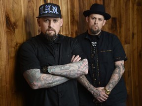 FILE - This July 10, 2018 file photo shows Benji Madden, left, and his twin brother Joel Madden of the rock band Good Charlotte in Burbank, Calif. The city of Annapolis, Md. will hold a benefit concert on July 28 featuring the Maryland-based band to honor the five Capital Gazette employees killed in an attack in their newsroom.