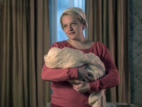 This image released by Hulu shows Elisabeth Moss in a scene from "The Handmaid's Tale." Moss was nominated Thursday for an Emmy for outstanding lead actress in a drama series. The 70th Emmy Awards will be held on Monday, Sept. 17.