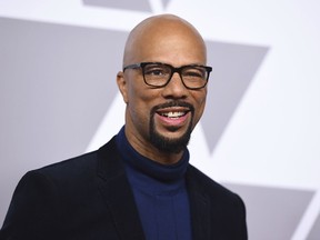 FILE - In this Feb. 5, 2018 file photo, Common arrives at the 90th Academy Awards Nominees Luncheon in Beverly Hills, Calif. Common showed up at P.S. 111 in midtown Manhattan on Thursday as an ambassador for the Adopt-A-Classroom initiative. He made the surprise appearance with his mother, Dr. Mahalia Hines, to present the school with a $10,000 check.