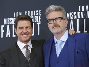 FILE - In this July 22, 2018 file photo, actor Tom Cruise, left, and director, writer, producer Christopher McQuarrie attend the premiere of "Mission: Impossible - Fallout" in Washington. McQuarrie didn't set out to make the most action-packed "Mission" film in the franchise. It just kind of happened by accident, and it's earning the franchise and Cruise some of the best reviews they've ever gotten.
