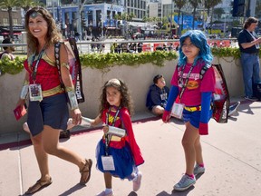 Dressed as Wonder Woman, Issa Jamie, 5, center, is joined by her mother Miriam and sister, Bonnie as they arrive for 2018 Comic-Con International at the San Diego Convention Center, Thursday, July 19, 2018, in San Diego.