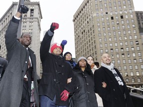 FILE - In this Jan. 17, 2012 file photo, Yusef Salaam, left, Kevin Richardson, second left, and Raymond Santana, right, react to supporters in New York. The three men who were exonerated in the 1989 Central Park Jogger case, were in court for a hearing in a $250 million federal lawsuit they filed against the city after their sentences were vacated. New York City has started releasing about 100,000 pages of documents connected to the notorious case of the five men whose convictions for raping and beating a Central Park jogger were overturned after they served more than a decade behind bars.