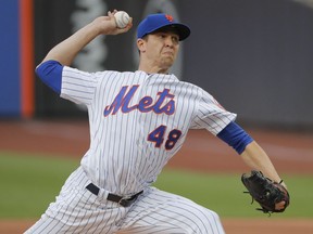 FILE - In this July 6, 2018, file photo, New York Mets starting pitcher Jacob deGrom (48) delivers against the Tampa Bay Rays during the first inning of a baseball game in New York. DeGrom says he'd love to play his entire career with the New York Mets, but he's not disputing comments by his agent that the team should either sign him to a long-term deal or trade him now.