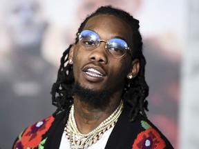 FILE - In this Dec. 13, 2017, file photo, Offset, of Migos, arrives at the U.S. premiere of "Bright" at the Regency Village Theatre in Los Angeles. Offset is facing two felony gun charges after he and his bodyguard were pulled over outside of Atlanta. Clayton County Police Sgt. Ashanti Marbury tells WSB-TV that an officer pulled over a Porsche 911 Friday afternoon, July 20, 2018, for failing to maintain its lane. Police said the vehicle smelled of marijuana, prompting authorities to search the car and find three guns and marijuana.