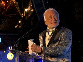 FILE - In this July 15, 2017, file photo, Apollo 11 astronaut Buzz Aldrin speaks at the commemoration for the upcoming anniversary of the 1969 mission to the moon and a gala for his non-profit space education foundation, ShareSpace Foundation, at the Kennedy Space Center in Cape Canaveral, Fla. Aldrin is expected to be noticeably absent from a gala kicking off a yearlong celebration of the 50-year anniversary of the first moon landing, even though his foundation is a sponsor and he typically is the star attraction. Organizers haven't heard one way or another if Aldrin is attending Saturday, July 21, 2018 evening's Apollo Celebration Gala at the Kennedy Space Center in Florida, but they expect him to be a no-show.