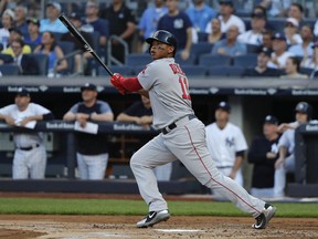Boston Red Sox's Rafael Devers connects for a grand slam against the New York Yankees during the first inning of a baseball game, Saturday, June 30, 2018, in New York.