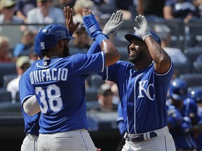 Kansas City Royals' Brian Goodwin, right, celebrates with Jorge Bonifacio (38) and Alex Gordon after hitting a three-run home run against the New York Yankees during the eighth inning of a baseball game, Saturday, July 28, 2018, in New York.