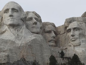 FILE - In this Dec. 9, 2016, file photo, the faces of the presidents that make up the Mount Rushmore monument are shown near Keystone, S.D. The PBS host Geoffrey Baer is back this summer with new episodes of his series "10 That Changed America" focusing on streets, monuments and marvels, including one show that gives the surprising inside story behind icons like the Statue of Liberty and Mount Rushmore.