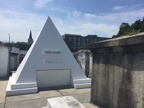 Actor Nicolas Cage is alive and well but he owns this gleaming tomb shaped like a pyramid in St. Louis Cemetery No. 1 in New Orleans, pictured in this June 3, 2018 photo. The white 9-foot-tall structure bears the words "omnia ab uno," which is Latin for "everything from one."