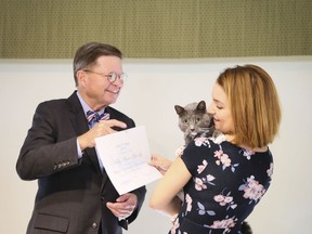 This undated photo provided by Eckerd College shows Eckerd College President Donald R. Eastman III presenting a certificate to a student's pet at a recent pet graduation ceremony in St. Petersburg, Fl. Eckerd is not the only campus in the country that allows pets, but they've been doing it the longest _ since the early 1970s. Leaving for college involves some difficult changes, and one of them can be separation from a beloved pet. If it's a high enough priority however you might be able to find a college that will let you bring your pet.