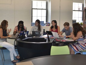 This 2017 photo provided by the French-American School of New York shows students working with an instructor in a science lab of the school's Harbor campus in Mamaroneck, N.Y. The French-American School of New York recently began offering the International Baccalaureate diploma.