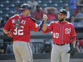 Washington Nationals relief pitcher Kelvin Herrera, right, and catcher Jamie Burke celebrate after the baseball game against the New York Mets at Citi Field, Sunday, July 15, 2018, in New York. The Nationals defeated the Mets 6-1.