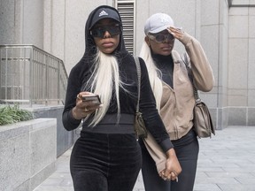 Shannade Clermont, right, and her twin sister Shannon leave Federal court in New York after her arraignment, Wednesday, July 11, 2018. Shannade Clermont, a former cast member of the television reality series "Bad Girls Club" was arrested on charges alleging she stole debit card information from a man who died shortly after a date with her.