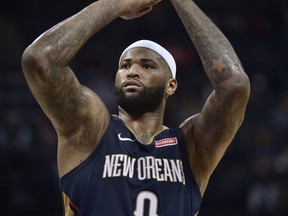 FILE - In this Jan. 10, 2018 file photo New Orleans Pelicans center DeMarcus Cousins (0) shoots a free throw in the first half of an NBA basketball game against the Memphis Grizzlies in Memphis, Tenn. Cousins will be ready to play at some point this season. And when he is, the two-time defending NBA champions will be waiting. Adding a fifth All-Star to their already glitzy lineup, the Golden State Warriors have come to terms with Cousins on a one-year, $5.3 million deal _ not the biggest money move on Day 2 of the NBA Free Agency period, but the most intriguing.