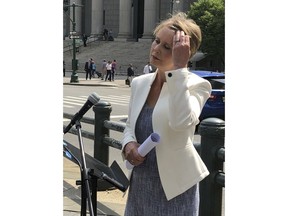 New York Democratic Gubernatorial hopeful Cynthia Nixon speaks to the media in front of Manhattan federal court in New York, Friday, July 13, 2018. Nixon said Friday that Gov. Andrew Cuomo should initiate a corruption probe in the wake of guilty verdicts at a corruption trial.
