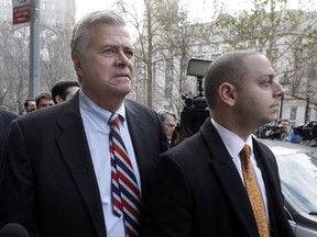 FILE - In this Dec. 11, 2015, file photo, former New York state Senate leader Dean Skelos, left, and his son Adam Skelos leave federal court, in New York. Skelos and his son have been convicted of bribery, wire fraud and extortion charges at their federal corruption trial on Tuesday, July 17, 2018. The two were accused of selling the once-powerful Republican's office by pressuring wealthy businessmen into giving Adam Skelos roughly $300,000 for no-show jobs.