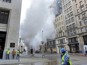 Steam billows on New York's Fifth Avenue, Thursday, July 19, 2018. A steam pipe exploded beneath the street in Manhattan early Thursday, sending chunks of asphalt flying, a geyser of billowing white steam stories into the air and forcing pedestrians to take cover.