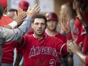 FILE - In this Thursday, July 5, 2018, file photo, Los Angeles Angels' Ian Kinsler is congratulated by teammates in the dugout after scoring against the Seattle Mariners during the fourth inning of a baseball game, in Seattle. In a deal announced late Monday, July 30, 2018, the Boston Red Sox have acquired Kinsler from the Los Angeles Angels to fill in for injured second baseman Dustin Pedroia.