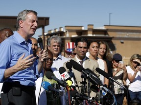 FILE - In this Thursday, June 21, 2018, file photo, New York Mayor Bill de Blasio speaks alongside a group of other U.S. mayors during a news conference outside a holding facility for immigrant children in Tornillo, Texas, near the Mexico border. U.S. Customs and Border Protection is alleging that de Blasio illegally crossed from Mexico into the U.S. while visiting the El Paso, Texas, area in June, an accusation the mayor's office flatly denies.